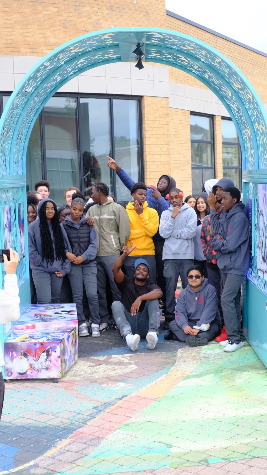 Young participants gathered around a completed installation