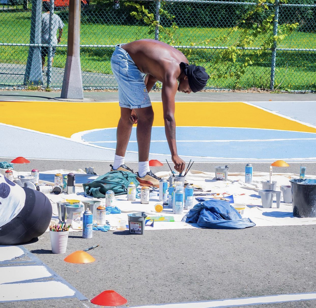 Dino painting a basketball court