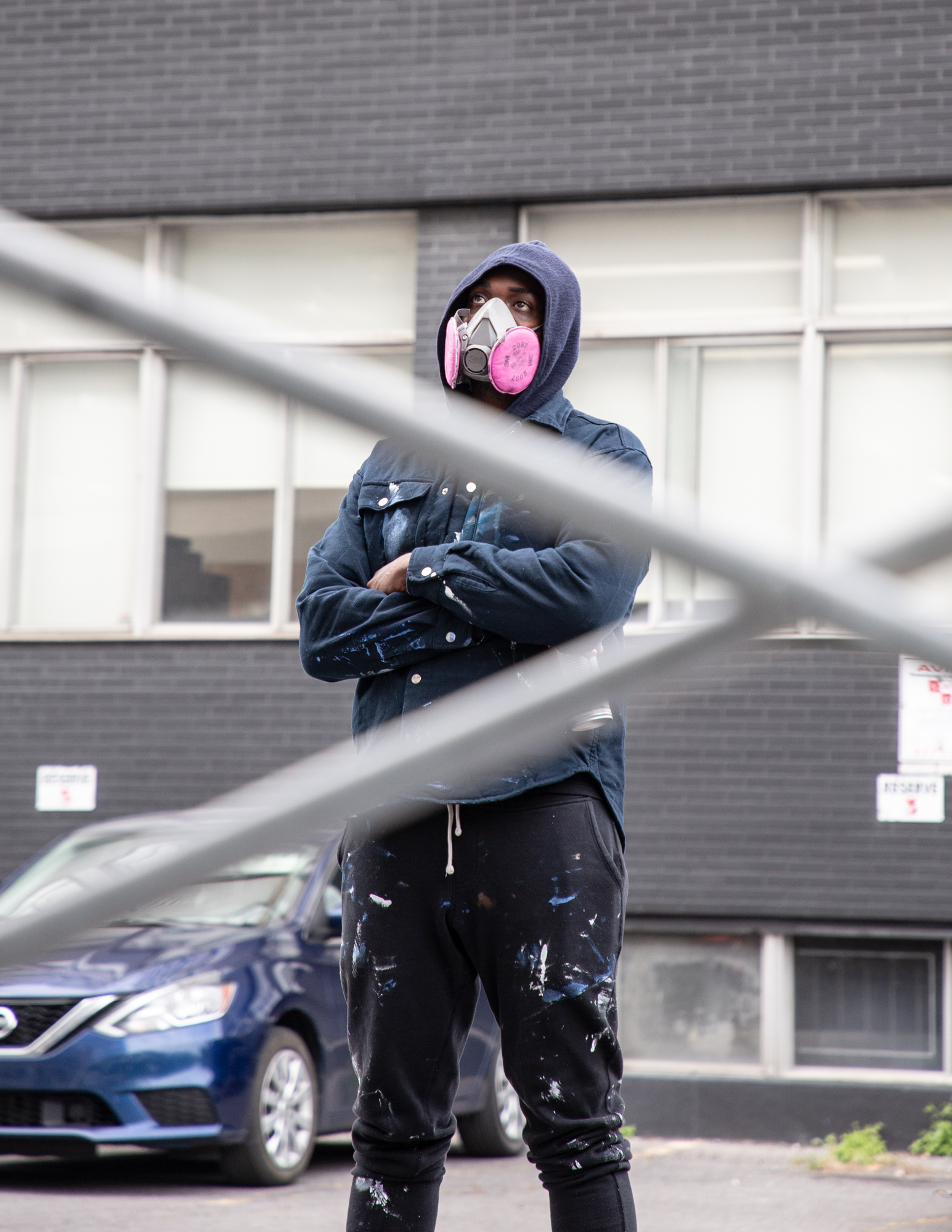 Dino in paint-covered work clothes wearing a respirator