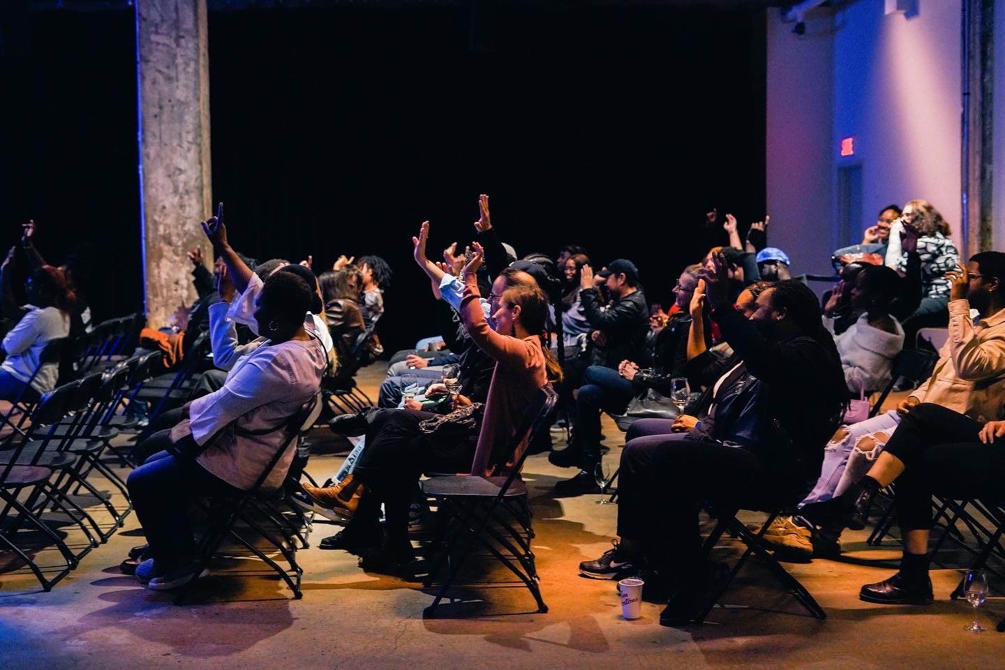Conference · audience raising hands
