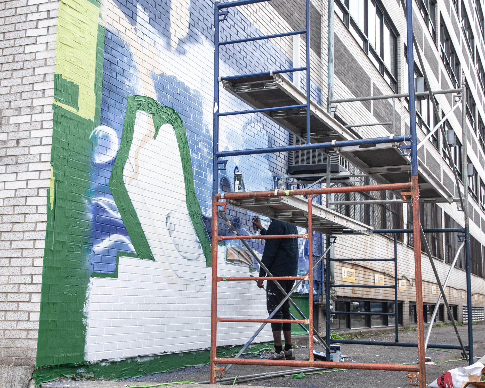 Évasion mural in progress on scaffolding