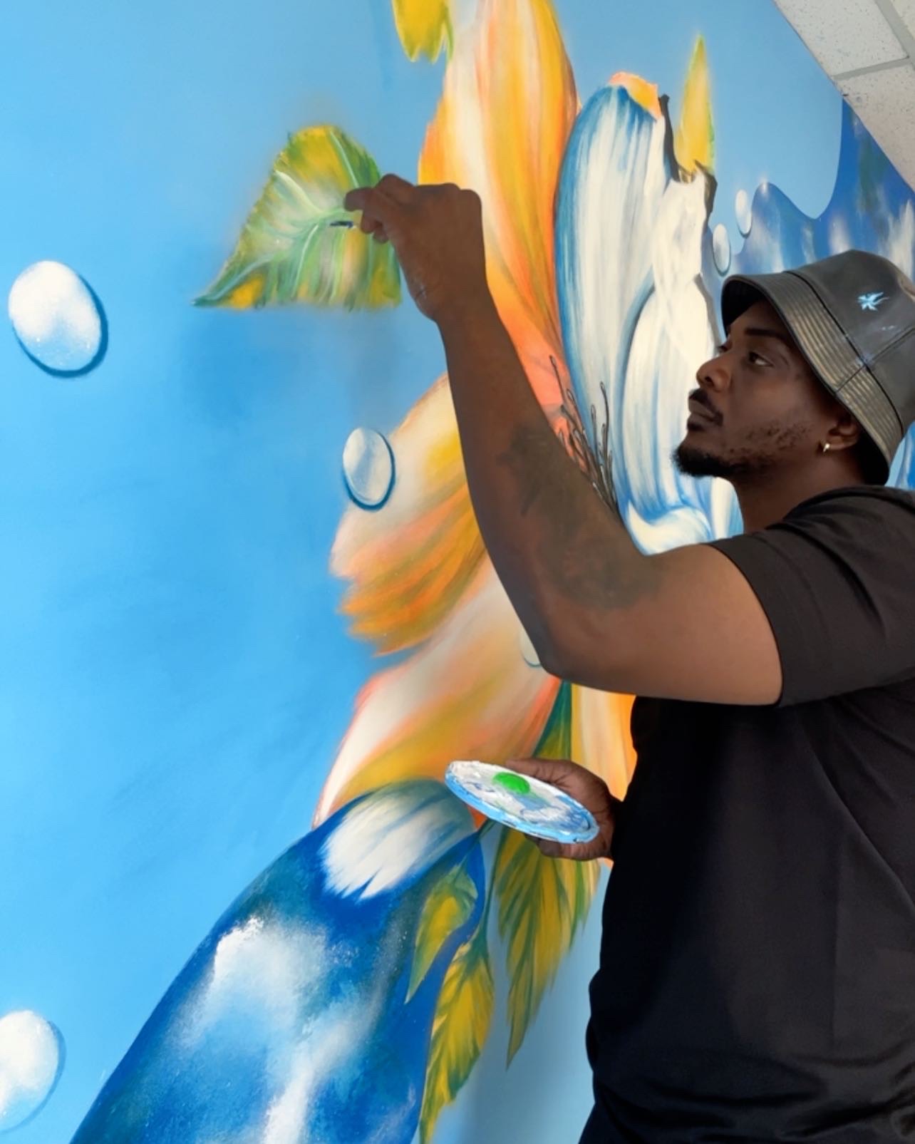 Artist painting the floral mural